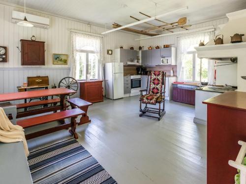 a kitchen with wooden floors and white appliances at Holiday Home Elfvik by Interhome in Porvoo