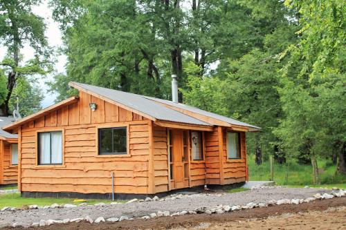 a small wooden cabin with a metal roof at Cabañas Peumayén Neltume in Neltume