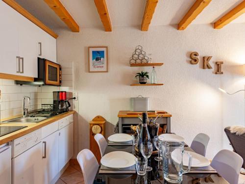 a kitchen with a table and chairs in a kitchen at Apartment les Huskies by Interhome in Saint-Gervais-les-Bains