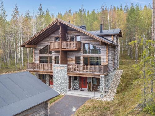 an aerial view of a log home with a deck at Holiday Home Karhunkieppi 9b- 2 skipasses included by Interhome in Levi