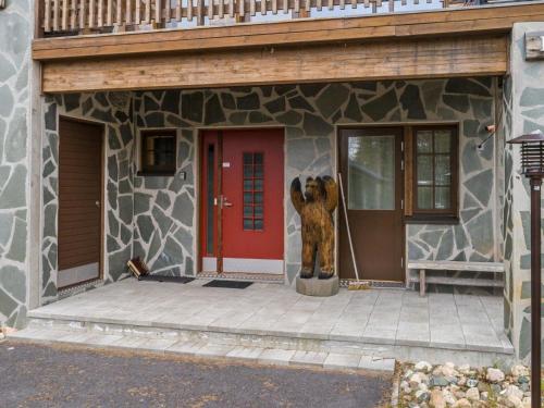 a building with a bear statue in front of it at Holiday Home Karhunkieppi 9b- 2 skipasses included by Interhome in Levi