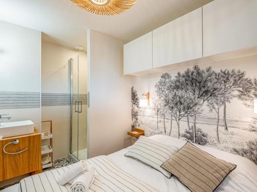 a bedroom with a bed and a bathroom with a shower at Studio La Cormorane-6 by Interhome in Carnac