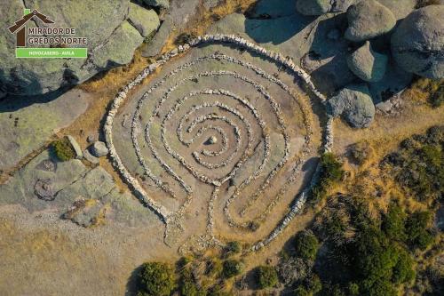 an aerial view of a stone spiral in the rocks at Casa el Mirador de Gredos Norte in Hoyocasero