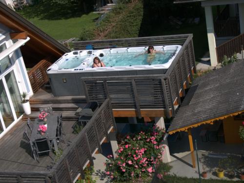 two people in a hot tub on a deck at Apartment Ligist by Interhome in Ligist
