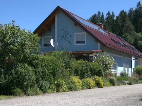 a house with a red roof and bushes at Apartment Ligist by Interhome in Ligist