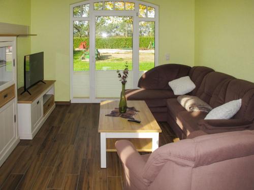 a living room with a couch and a table at Apartment Rose by Interhome in Zarrentin