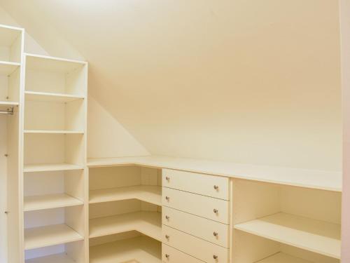 a walk in closet with white shelves at Apartment Ligist by Interhome in Ligist
