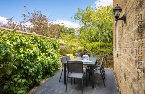 a table and chairs sitting on a patio at Birch House in Stow on the Wold