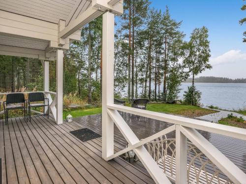 a porch of a house with a view of the water at Holiday Home Tyssinniemi by Interhome in Hiukkajoki