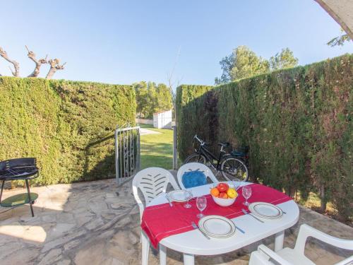 a white table with a bowl of fruit on a patio at Apartment Residencial Eurosol de los Monteros by Interhome in Miami Platja