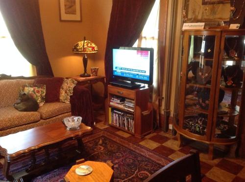 a living room with a couch and a television at Delano Bed and Breakfast in Wichita
