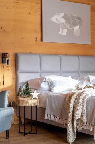 a bedroom with a large bed with a table at Wierchowa Chata in Kościelisko