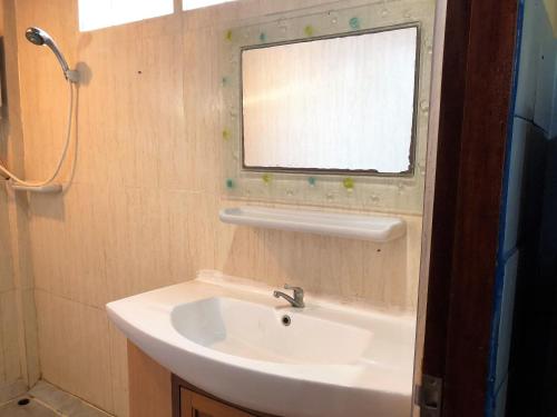 a bathroom with a sink and a window at Lam Sai village hotel in Ban Laem Sai