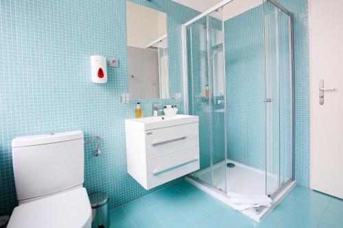 a bathroom with a shower and a toilet and a sink at Apartments Embassy by LH in Prague