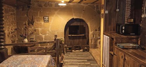 a room with a table and a room with an archway at La Casa del Ayer in Ábalos