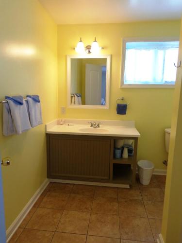 a bathroom with a sink and a mirror at A Holiday Motel - Maggie Valley in Maggie Valley