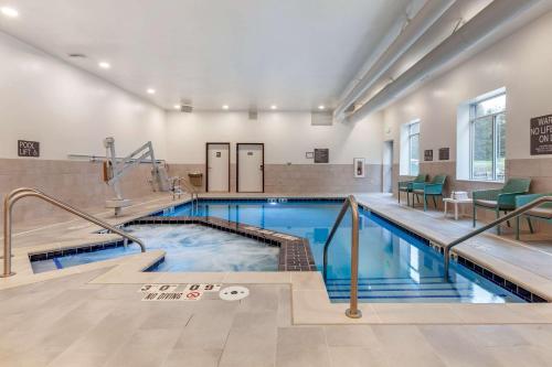 a pool in a building with a swimming pool at Comfort Suites Cottage Grove-Madison in Cottage Grove