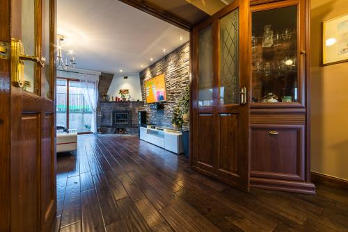 a large kitchen with wooden floors and wooden cabinets at Willa , Cosy house in Inverness in Inverness