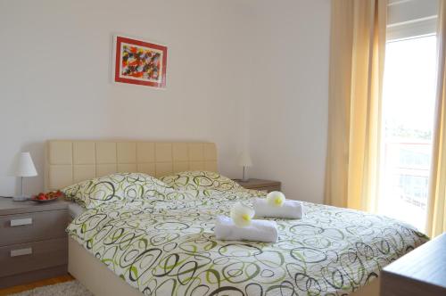 a bedroom with a bed with two towels on it at Apartment Silvija sea view in Umag