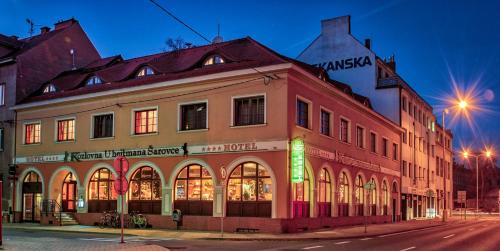 a building on the corner of a street at night at Hotel U Hejtmana Šarovce in Uherské Hradiště