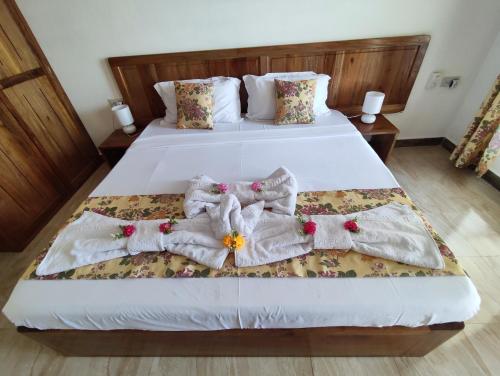 a bedroom with two beds with blankets and pillows at La Residence D'Almee Guesthouse in Anse Possession