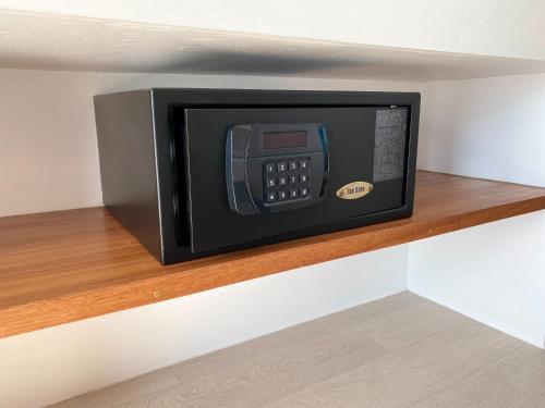 a microwave oven sitting on a shelf in a room at Blue Tao Beach Hotel - SHA Plus in Koh Tao