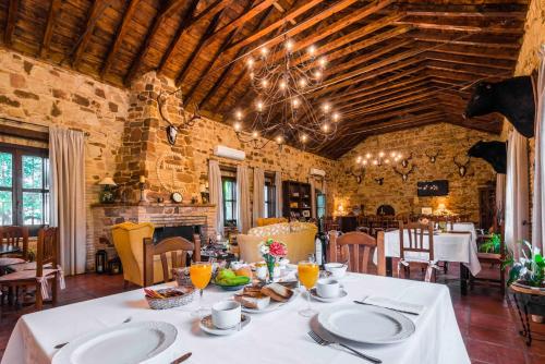 a dining room with a table with white plates at Finca El Cotillo in Linares