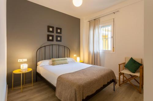 セビリアにあるJosé Gestoso Sevilla Urbanのベッドルーム1室(ベッド1台、椅子、窓付)