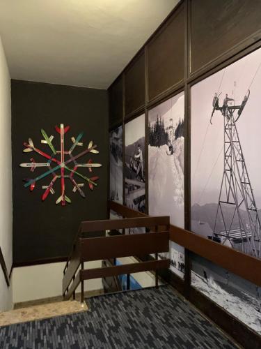 a bench in a room with a clock on the wall at Hotel SKI in Demanovska Dolina