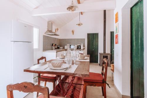 a kitchen and dining room with a table and chairs at Cá Estamos ~ Hortacasa Portugal in Santiago do Cacém
