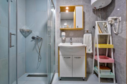 a bathroom with a sink and a shower at Bella Gondola Zlatibor in Zlatibor