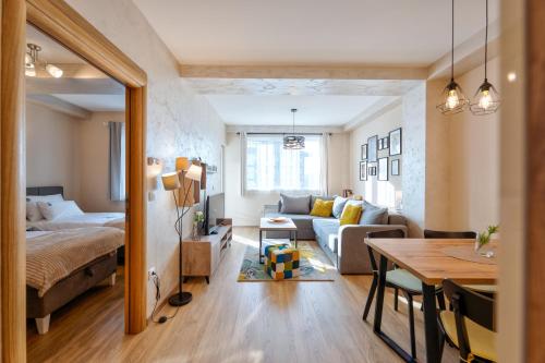 a bedroom and living room with a bed and a table at Bella Gondola Zlatibor in Zlatibor
