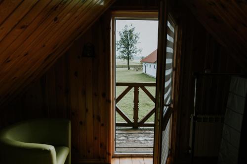 an open door to a room with a view of a barn at Zielone Zagrody - Cieplice in Adamówka