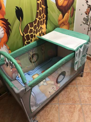 a play cart with a crib in a childs room at SWEET HOME LULLABY - free parking in Passoscuro