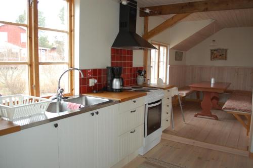 a kitchen with a sink and a counter top at Backlund Boende i Dalarna in Rättvik