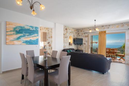 a living room with a table and a couch at Villa Mounda Apollon in Ratzaklíon