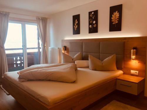 a bedroom with a large bed with a window at Gielerhof in Zell am Ziller