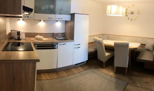 a small kitchen with a table and a dining room at Gielerhof in Zell am Ziller
