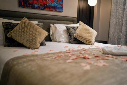 a bedroom with a bed with flowers on it at Balmoral Hotel, Belfast in Belfast