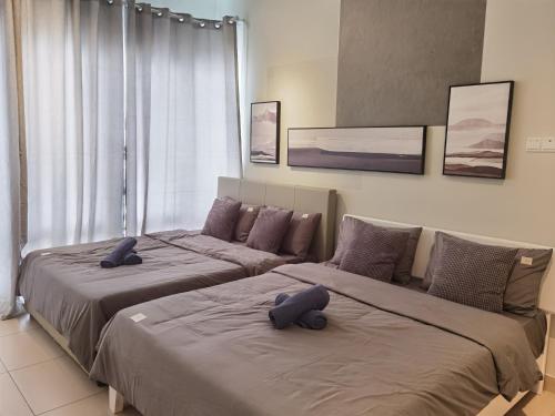 two beds sitting next to each other in a bedroom at Vest Home@Midhill Genting Highlands(Free WiFi) in Bentong