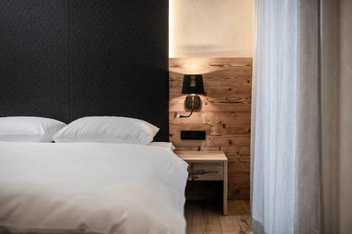 a bedroom with two beds and a table with a lamp at LaMonte Luxury Apartments in Kitzbühel