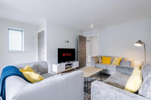 a living room with two couches and a tv at Weaver House in Chester