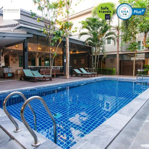 a swimming pool at a hotel with a resort at At Residence Suvarnabhumi Hotel in Lat Krabang