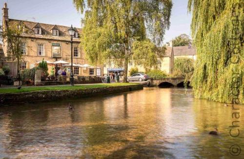 a river in a city with ducks in the water at Flynn's Barn in Aylworth
