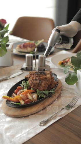 a table with a plate of food on a table at ADAM Hotel Suites in Tunis