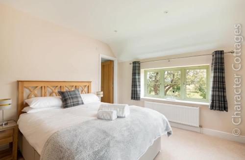 a bedroom with a large bed and a window at Mount View in Childs Wickham
