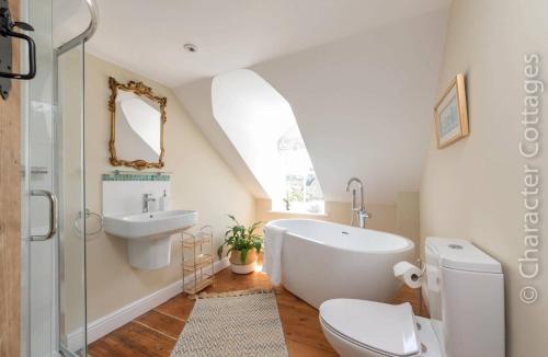 a bathroom with a sink toilet and a tub at Copperbeech in Stow on the Wold