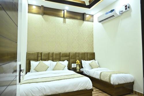 a bedroom with two beds in a room at GUNTAS RESIDENCY in Amritsar