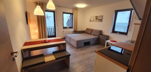 a small living room with a couch and a table at Haus Schneider in Winterberg