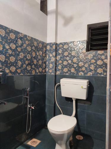 a bathroom with a toilet and a sink at INDRAYANI GUEST HOUSE in Calangute